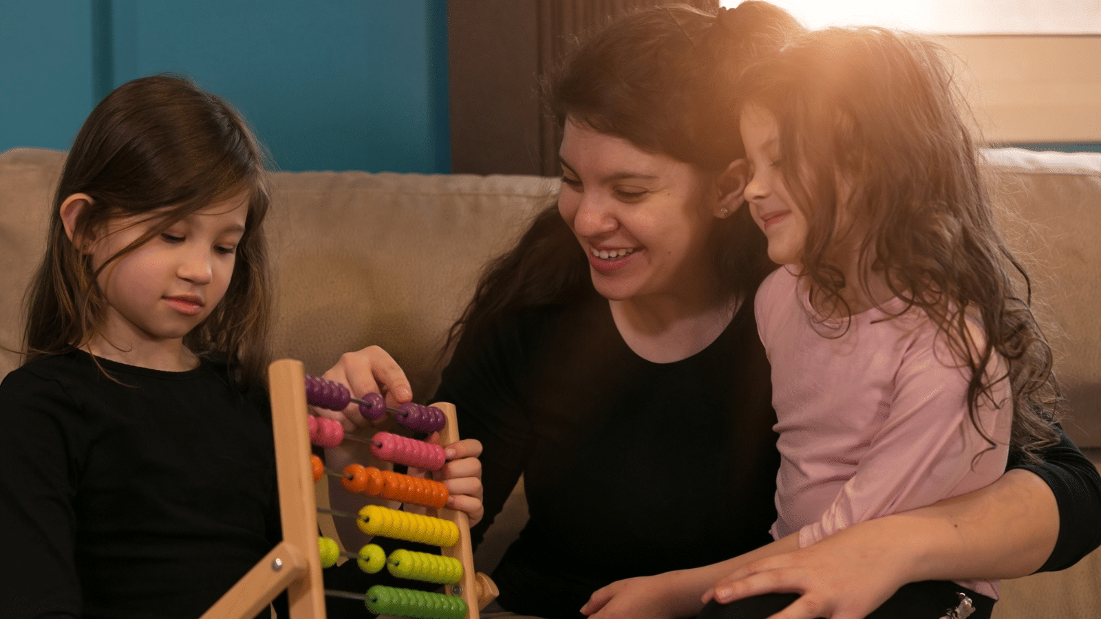 A mom playing with her two kids.