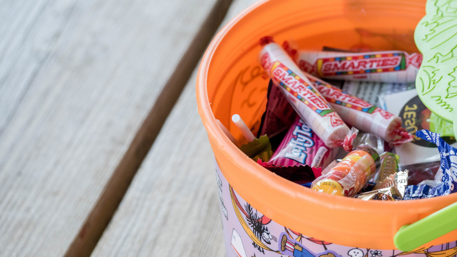A Halloween bucket filled with candy.