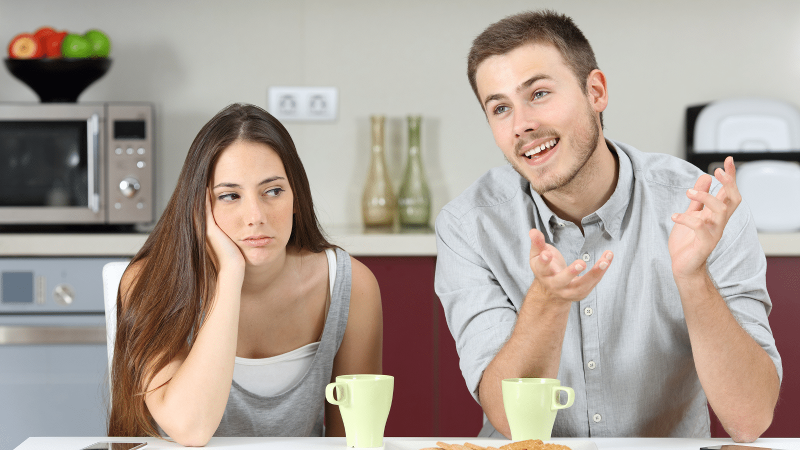 man talking and woman annoyed