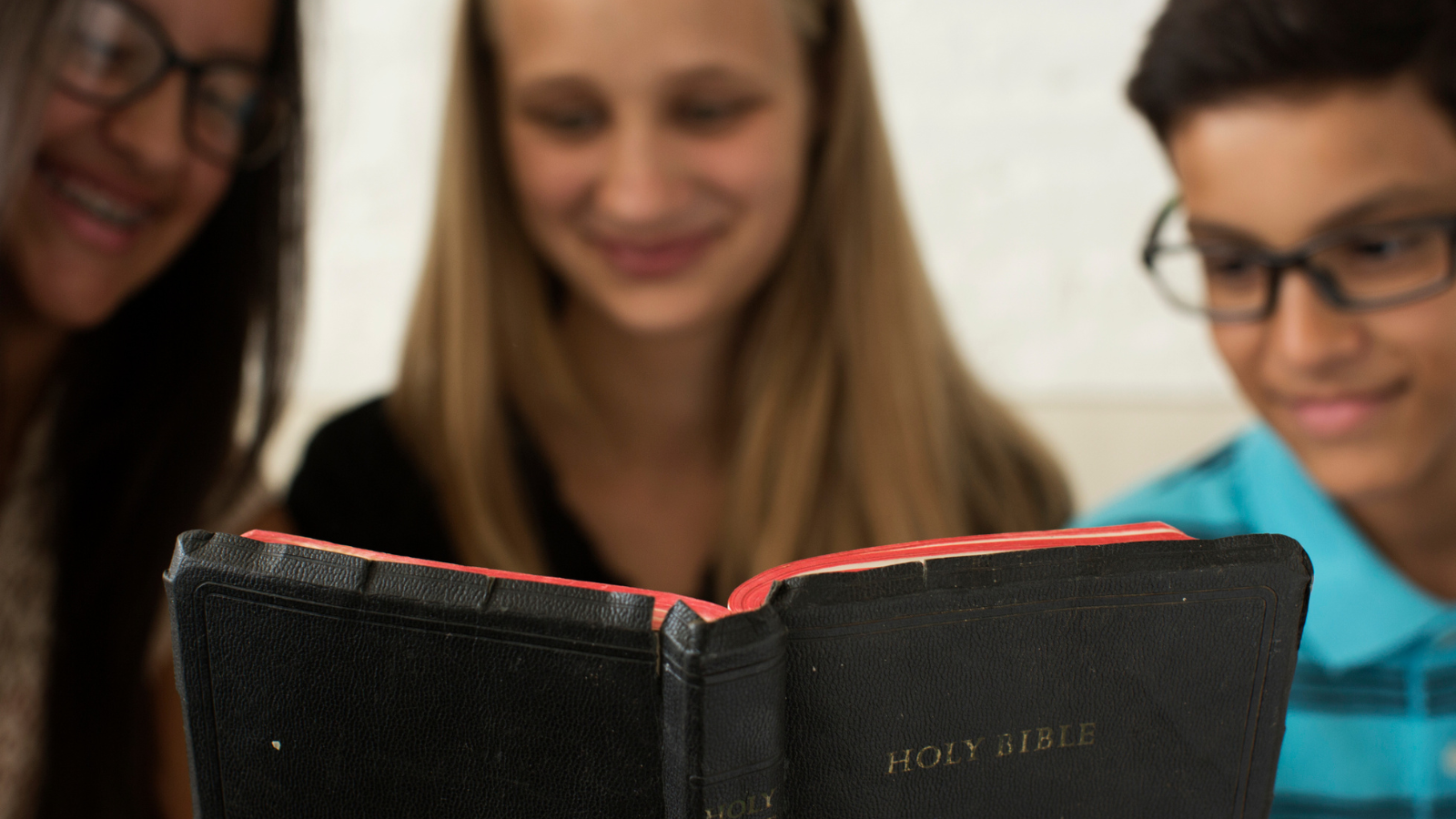friends reading the Bible together