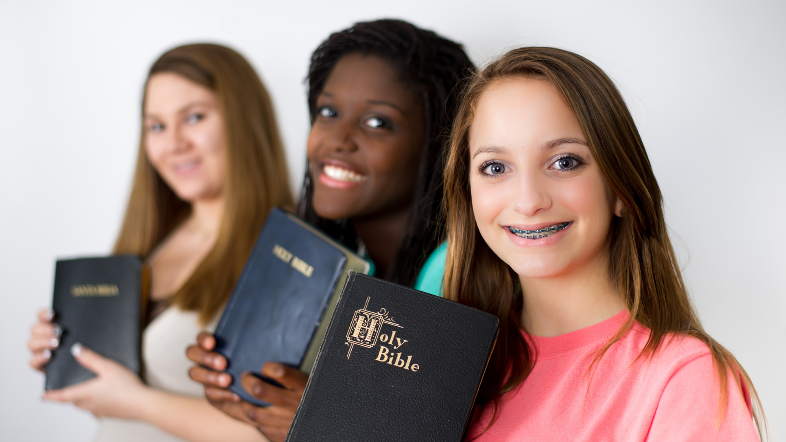 friends showing off their Bibles