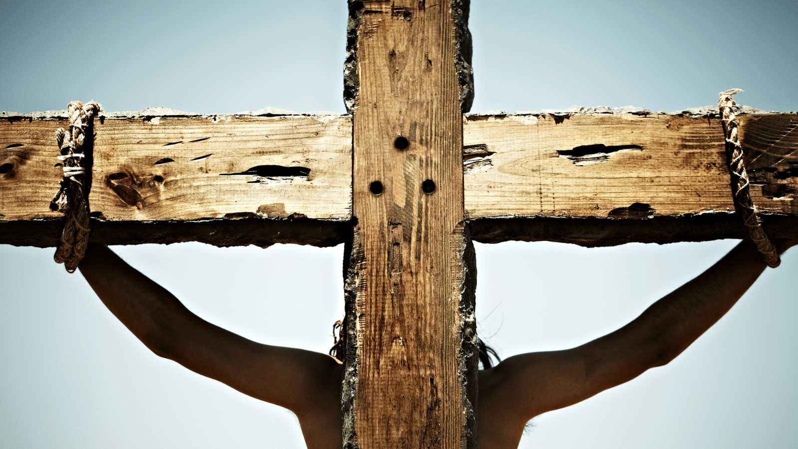 A man depicting Jesus on the cross.