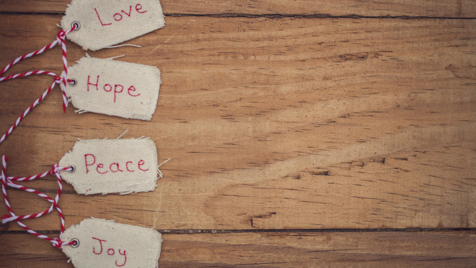 Advent tags that read love, hope, peace and joy.