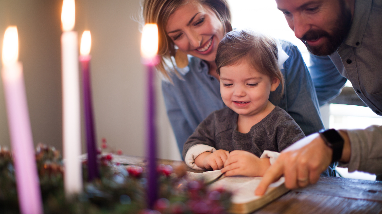 A family reading a bible for Advent.