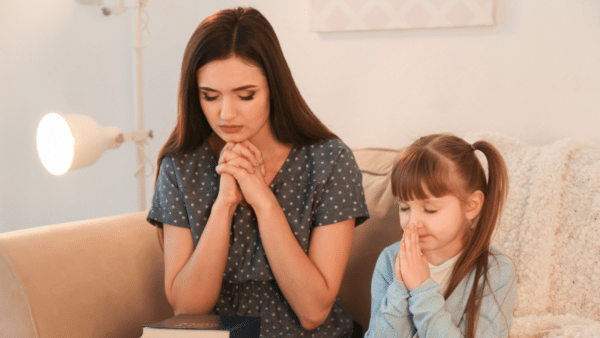mother and daughter praying