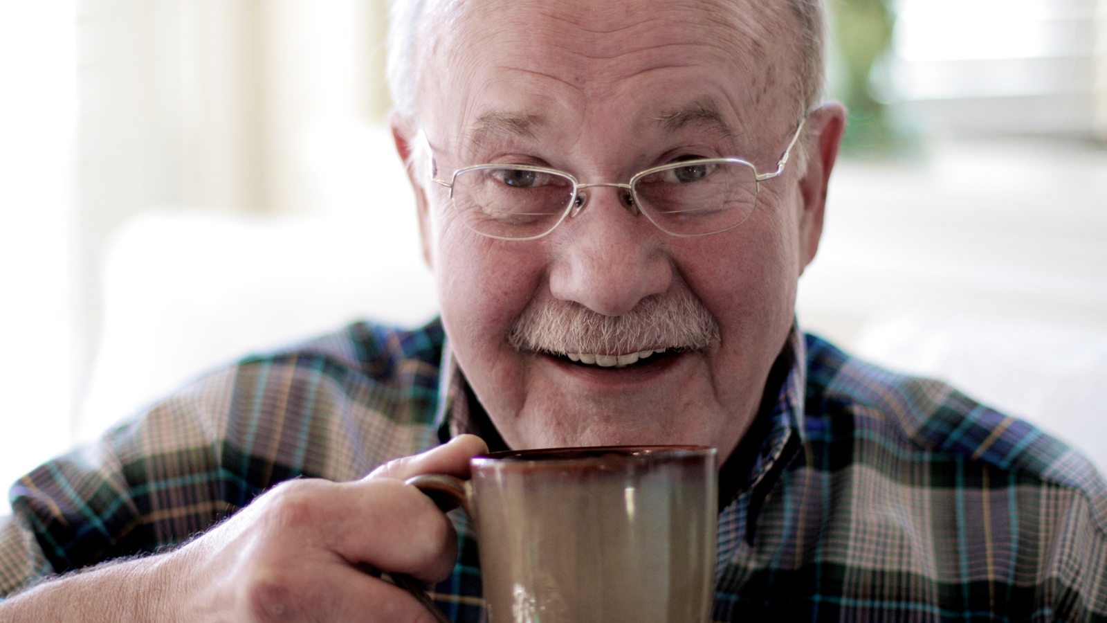 elderly man drinking coffee