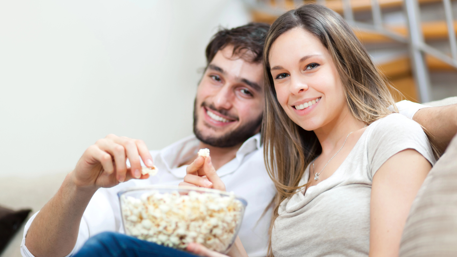 Couple Eating Popcorn While Watching a Movie
