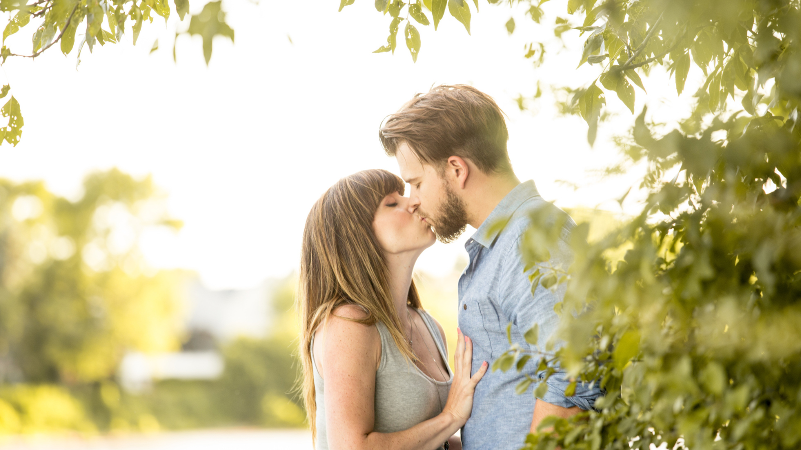 Couple kissing by a tree
