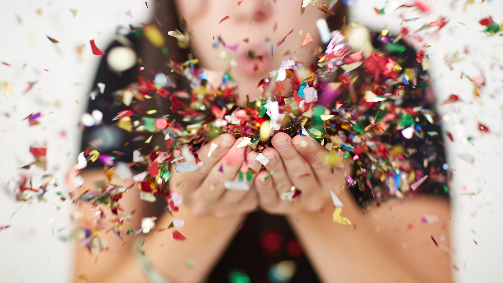 Woman blowing on confetti