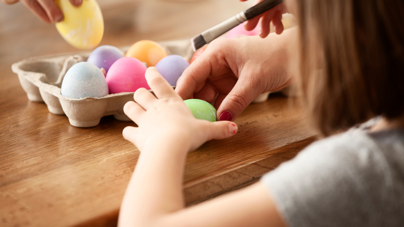 Child coloring an egg for Easter