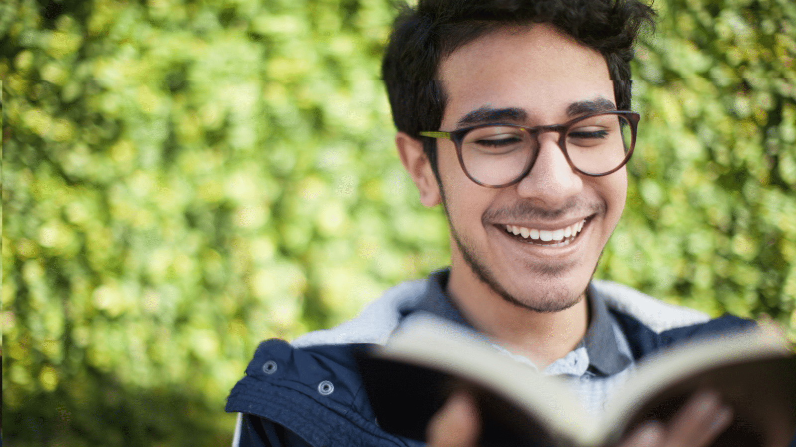 man holding Bible smiling