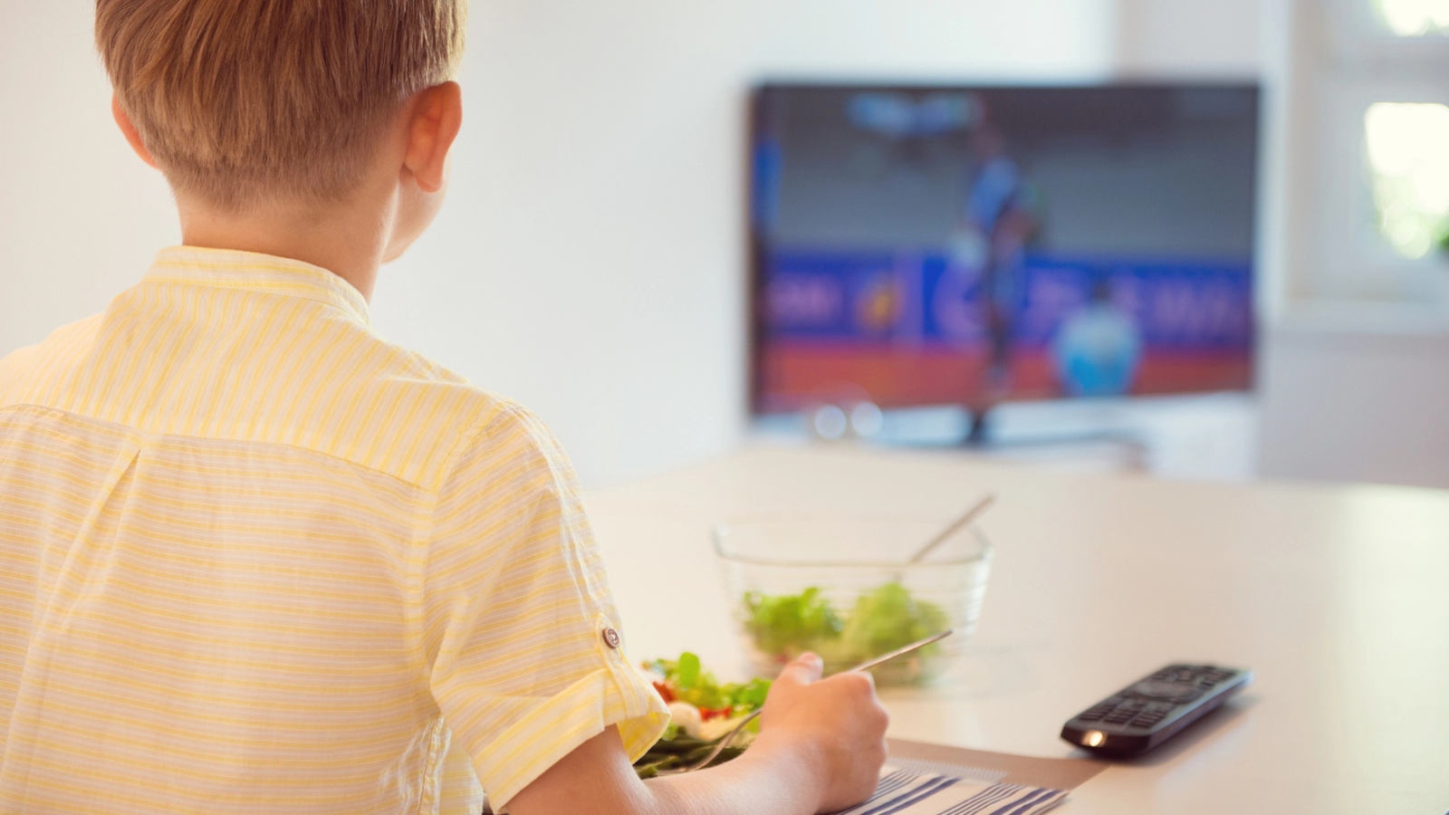 Boy eating in front of the tv