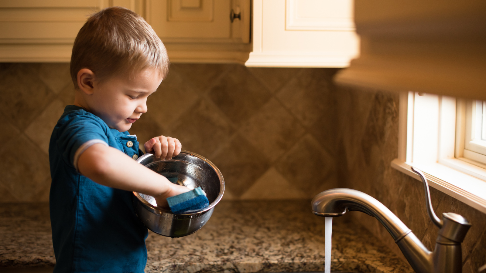 Boy washing a dish