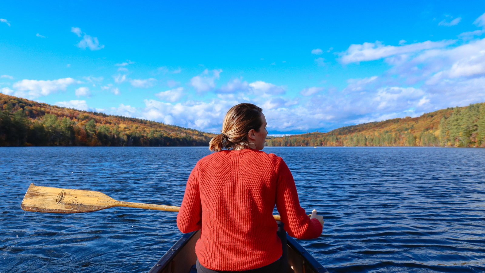 Woman sitting in a canoe on a lake
